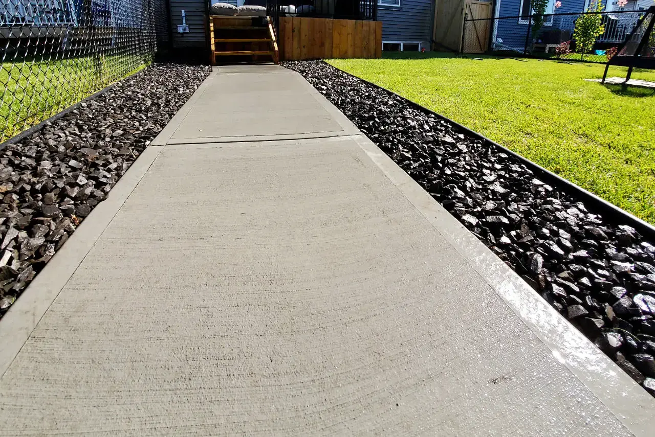 Smooth finished concrete pathway with decorative edging and professional finish