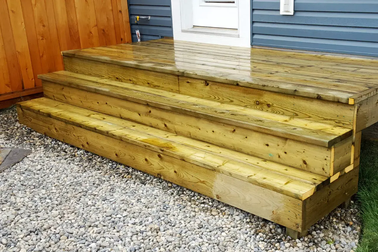 Large backyard deck with professional staining and strategic lighting