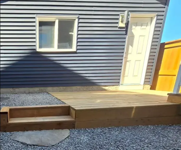 Custom wooden deck with beautiful railing and modern outdoor furniture