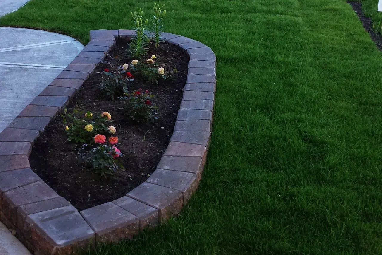 Natural stone patio with integrated raised flowerbed and planting area