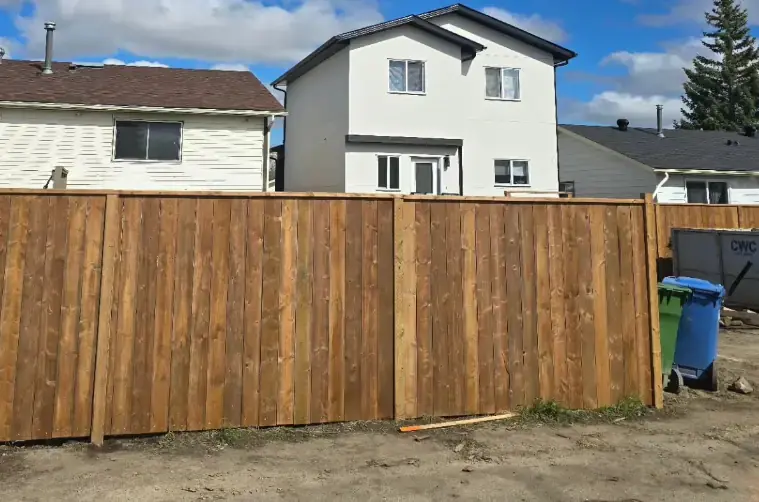 Tall privacy fence with uniform panels and professional installation